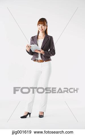 Full length portrait of Japanese young businesswoman against white background View Large Photo Image Stock Photo - Full length portrait of Japanese young businesswoman against white background. Fotosearch