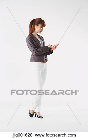 Full length portrait of Japanese young businesswoman against white background View Large Photo Image Stock Photo - Full length portrait of Japanese young businesswoman against white background. Fotosearch