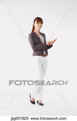 Full length portrait of Japanese young businesswoman against white background View Large Photo Image Stock Photo - Full length portrait of Japanese young businesswoman against white background. Fotosearch
