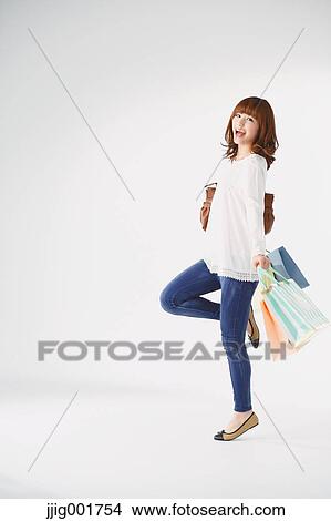 Full length portrait of young Japanese woman against white background View Large Photo Image Picture - Full length portrait of young Japanese woman against white background. Fotosearch