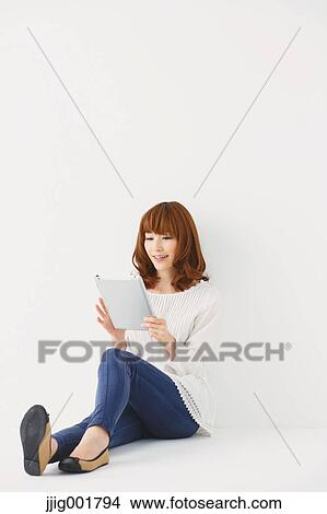 Full length portrait of young Japanese woman against white background View Large Photo Image Picture - Full length portrait of young Japanese woman against white background. Fotosearch