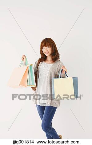 Picture - Full length portrait of young Japanese woman against white background. Fotosearch