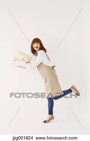 Picture - Full length portrait of young Japanese woman against white background. Fotosearch