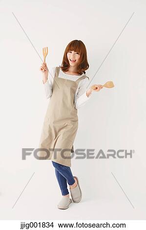 Picture - Full length portrait of young Japanese woman against white background. Fotosearch