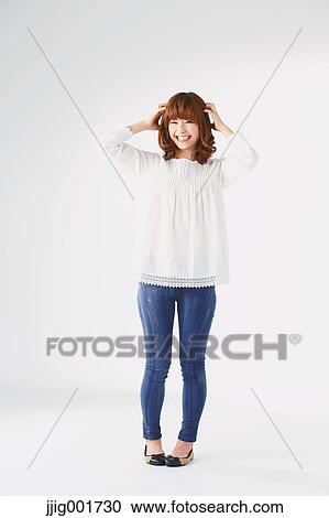 Full length portrait of young Japanese woman against white background View Large Photo Image Stock Image - Full length portrait of young Japanese woman against white background. Fotosearch