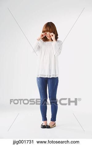Full length portrait of young Japanese woman against white background View Large Photo Image Stock Image - Full length portrait of young Japanese woman against white background. Fotosearch