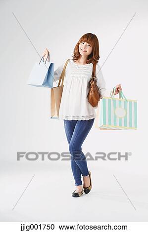 Full length portrait of young Japanese woman against white background View Large Photo Image Stock Image - Full length portrait of young Japanese woman against white background. Fotosearch