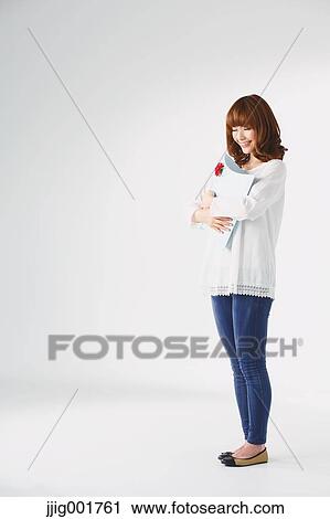 Full length portrait of young Japanese woman against white background View Large Photo Image Stock Image - Full length portrait of young Japanese woman against white background. Fotosearch