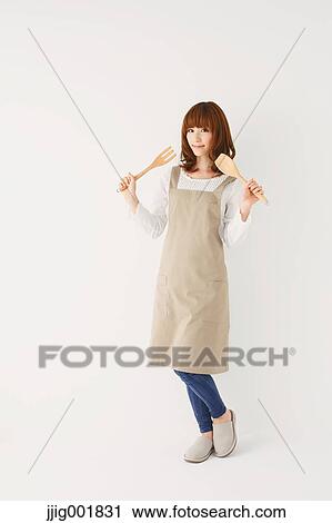 Stock Image - Full length portrait of young Japanese woman against white background. Fotosearch