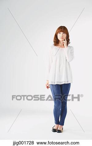 Full length portrait of young Japanese woman against white background View Large Photo Image Stock Photo - Full length portrait of young Japanese woman against white background. Fotosearch