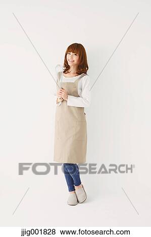 Stock Photo - Full length portrait of young Japanese woman against white background. Fotosearch