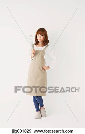 Stock Photo - Full length portrait of young Japanese woman against white background. Fotosearch
