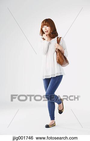 Full length portrait of young Japanese woman against white background View Large Photo Image Stock Photograph - Full length portrait of young Japanese woman against white background. Fotosearch