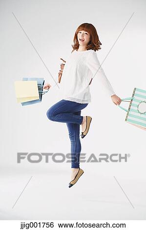 Full length portrait of young Japanese woman against white background View Large Photo Image Stock Photograph - Full length portrait of young Japanese woman against white background. Fotosearch