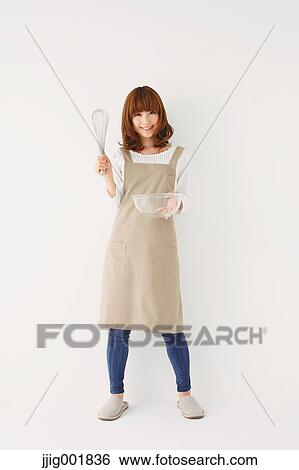 Stock Photograph - Full length portrait of young Japanese woman against white background. Fotosearch