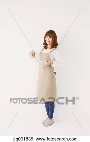 Stock Photography - Full length portrait of young Japanese woman against white background. Fotosearch