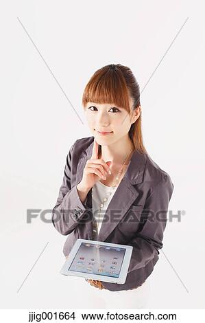 Half length portrait of Japanese young businesswoman against white background View Large Photo Image Picture - Half length portrait of Japanese young businesswoman against white background. Fotosearch