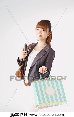 Half length portrait of Japanese young businesswoman against white background View Large Photo Image Picture - Half length portrait of Japanese young businesswoman against white background. Fotosearch