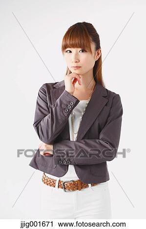 Stock Image - Half length portrait of Japanese young businesswoman against white background. Fotosearch