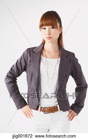 Stock Image - Half length portrait of Japanese young businesswoman against white background. Fotosearch