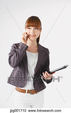 Half length portrait of Japanese young businesswoman against white background View Large Photo Image Stock Image - Half length portrait of Japanese young businesswoman against white background. Fotosearch