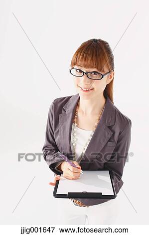 Stock Photo - Half length portrait of Japanese young businesswoman against white background. Fotosearch