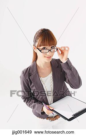 Stock Photo - Half length portrait of Japanese young businesswoman against white background. Fotosearch