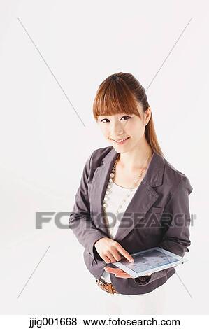 Half length portrait of Japanese young businesswoman against white background View Large Photo Image Stock Photo - Half length portrait of Japanese young businesswoman against white background. Fotosearch