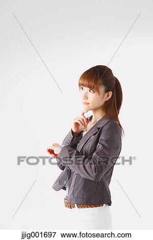 Stock Photo - Half length portrait of Japanese young businesswoman against white background. Fotosearch