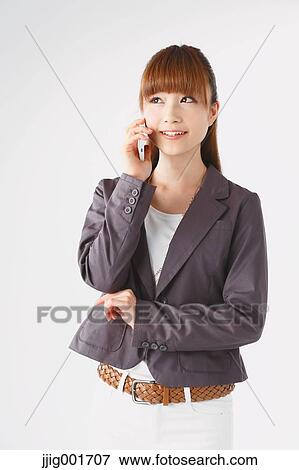 Half length portrait of Japanese young businesswoman against white background View Large Photo Image Stock Photo - Half length portrait of Japanese young businesswoman against white background. Fotosearch