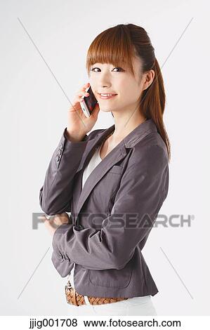 Half length portrait of Japanese young businesswoman against white background View Large Photo Image Stock Photo - Half length portrait of Japanese young businesswoman against white background. Fotosearch