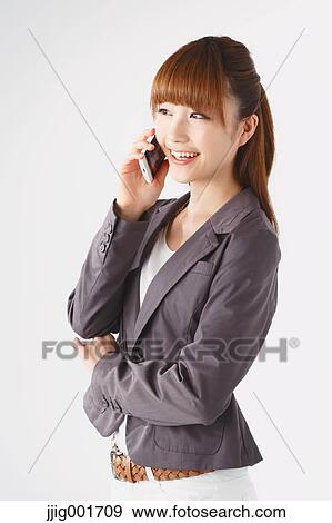 Stock Photo - Half length portrait of Japanese young businesswoman against white background. Fotosearch