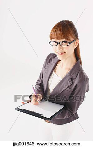 Stock Photograph - Half length portrait of Japanese young businesswoman against white background. Fotosearch