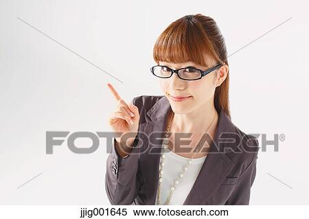 Stock Photography - Half length portrait of Japanese young businesswoman against white background. Fotosearch