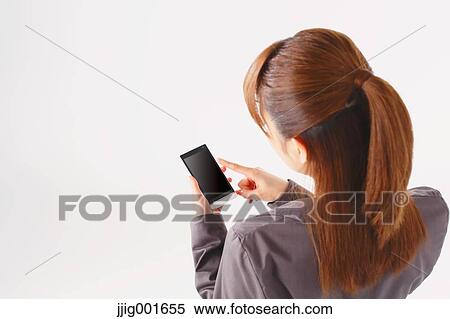 Stock Photography - Half length portrait of Japanese young businesswoman against white background. Fotosearch