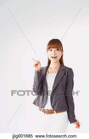 Stock Photography - Half length portrait of Japanese young businesswoman against white background. Fotosearch