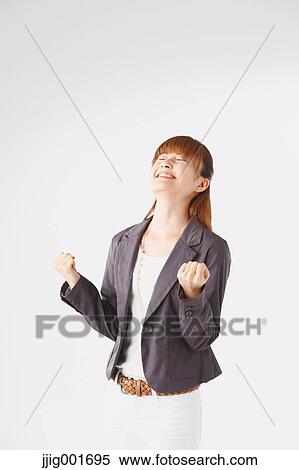 Stock Photography - Half length portrait of Japanese young businesswoman against white background. Fotosearch