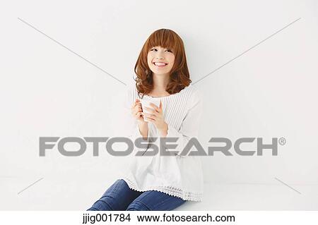 Half length portrait of young Japanese woman against white background View Large Photo Image Picture - Half length portrait of young Japanese woman against white background. Fotosearch