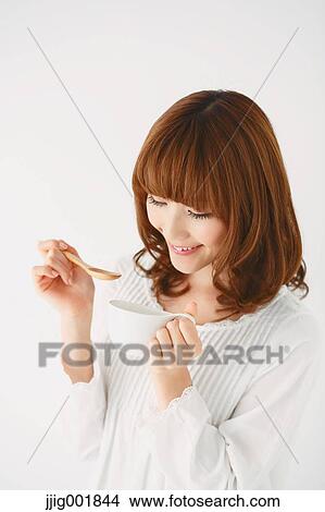Picture - Half length portrait of young Japanese woman against white background. Fotosearch