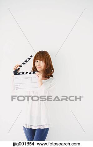 Picture - Half length portrait of young Japanese woman against white background. Fotosearch
