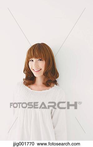 Half length portrait of young Japanese woman against white background View Large Photo Image Stock Image - Half length portrait of young Japanese woman against white background. Fotosearch