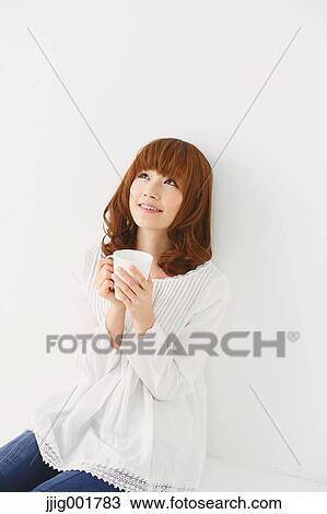 Half length portrait of young Japanese woman against white background View Large Photo Image Stock Image - Half length portrait of young Japanese woman against white background. Fotosearch