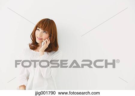 Half length portrait of young Japanese woman against white background View Large Photo Image Stock Image - Half length portrait of young Japanese woman against white background. Fotosearch