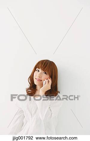 Half length portrait of young Japanese woman against white background View Large Photo Image Stock Image - Half length portrait of young Japanese woman against white background. Fotosearch