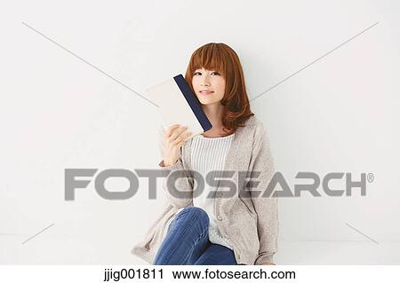 Half length portrait of young Japanese woman against white background View Large Photo Image Stock Image - Half length portrait of young Japanese woman against white background. Fotosearch
