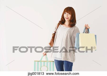Half length portrait of young Japanese woman against white background View Large Photo Image Stock Image - Half length portrait of young Japanese woman against white background. Fotosearch