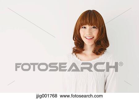 Stock Photo - Half length portrait of young Japanese woman against white background. Fotosearch