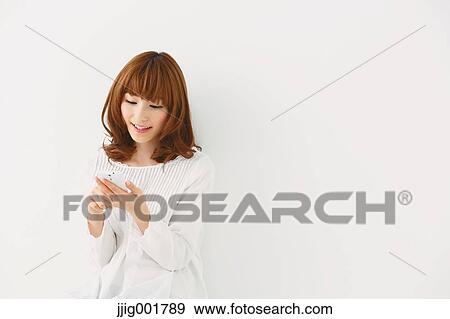 Half length portrait of young Japanese woman against white background View Large Photo Image Stock Photo - Half length portrait of young Japanese woman against white background. Fotosearch