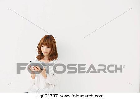 Half length portrait of young Japanese woman against white background View Large Photo Image Stock Photo - Half length portrait of young Japanese woman against white background. Fotosearch