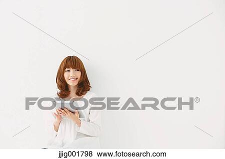 Half length portrait of young Japanese woman against white background View Large Photo Image Stock Photo - Half length portrait of young Japanese woman against white background. Fotosearch